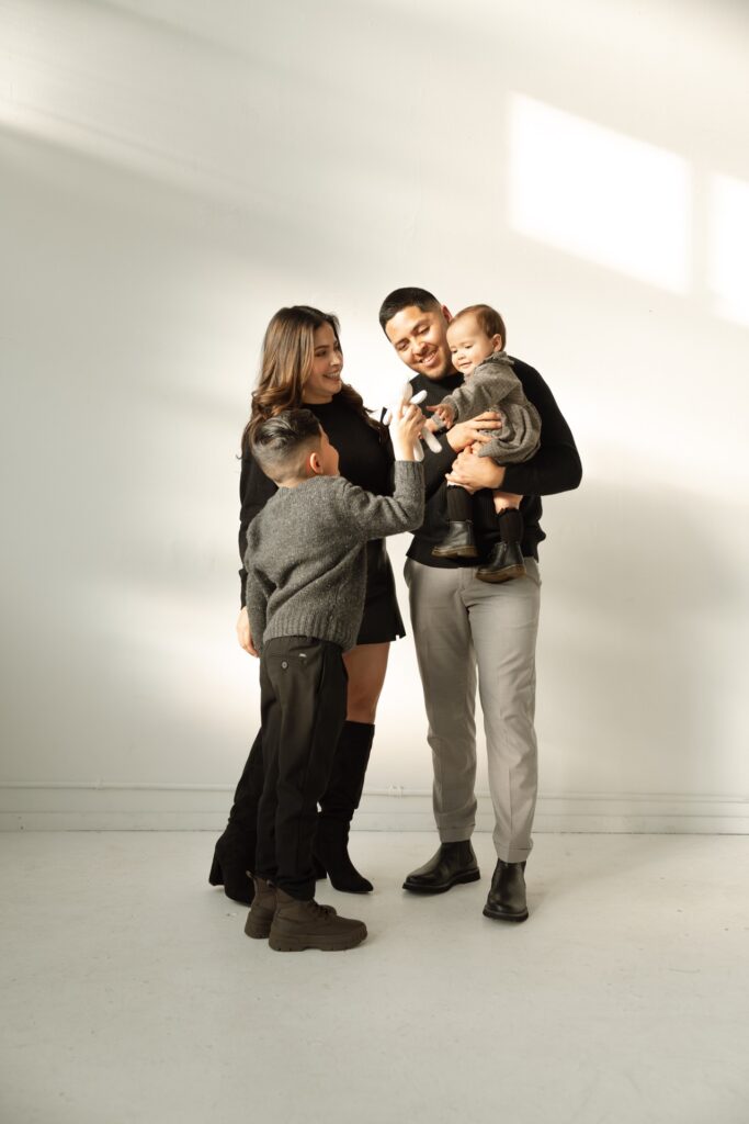 A family studio portrait of male and female playing with baby and son at Northlight Studio near Seattle, WA