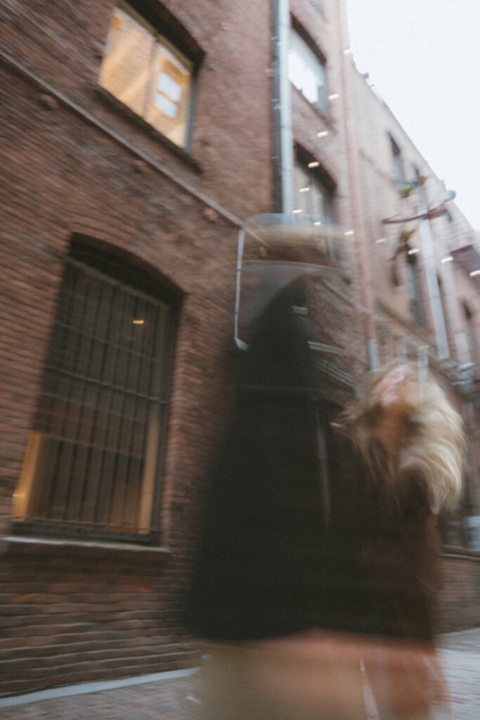 A blurry portrait of a male and a female couple walking in alleyway near Pioneer Square, Seattle.