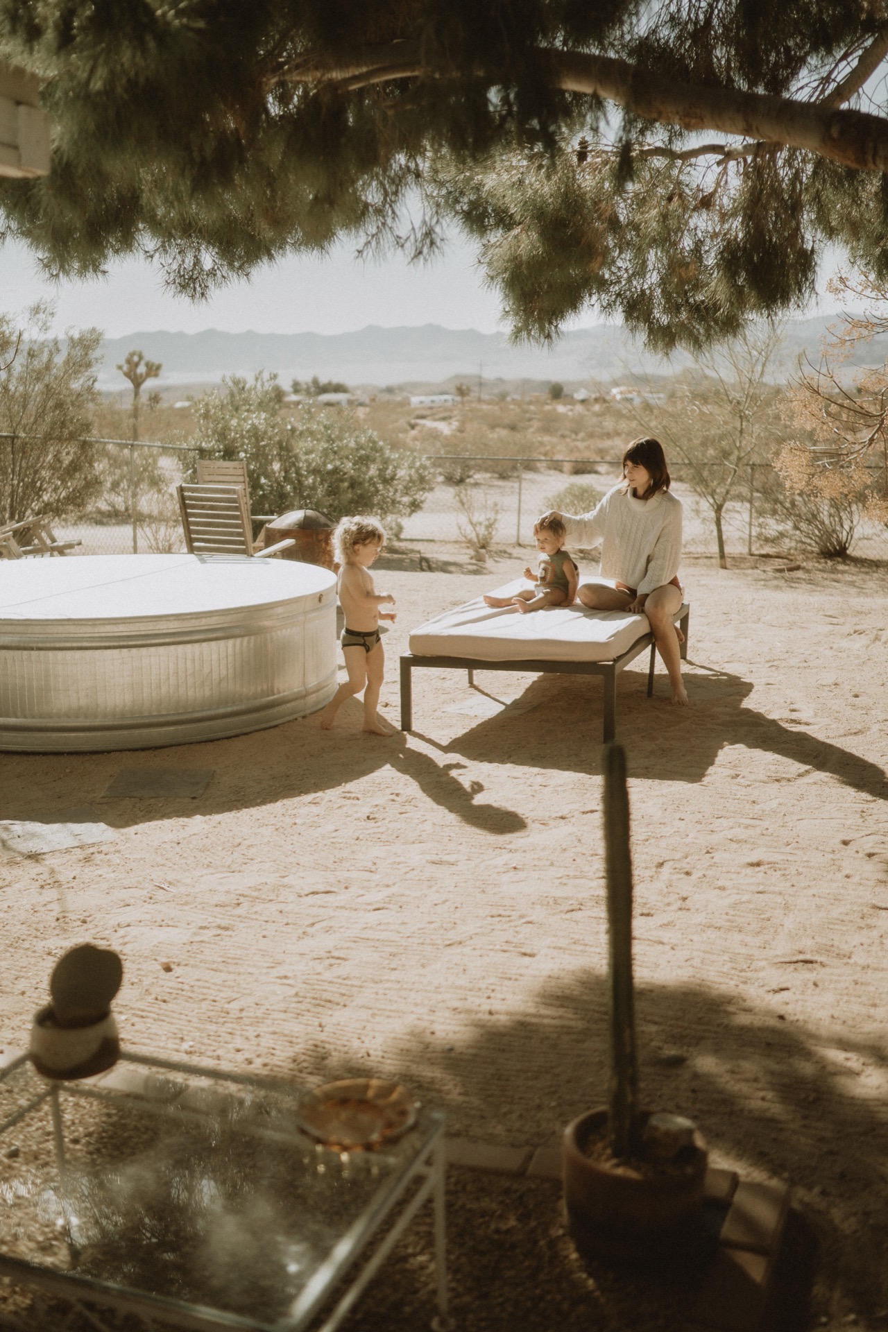 A family photo of a female sitting in a garden setting with two small children near Yucca Valley, California.