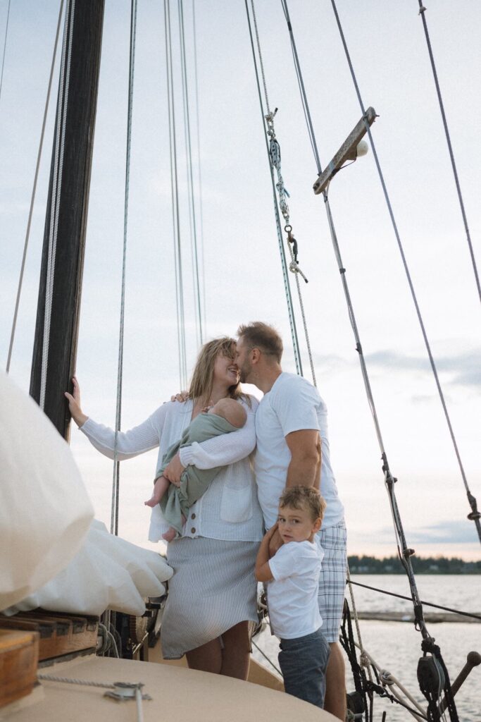 Family of four aboard a vintage sailboat