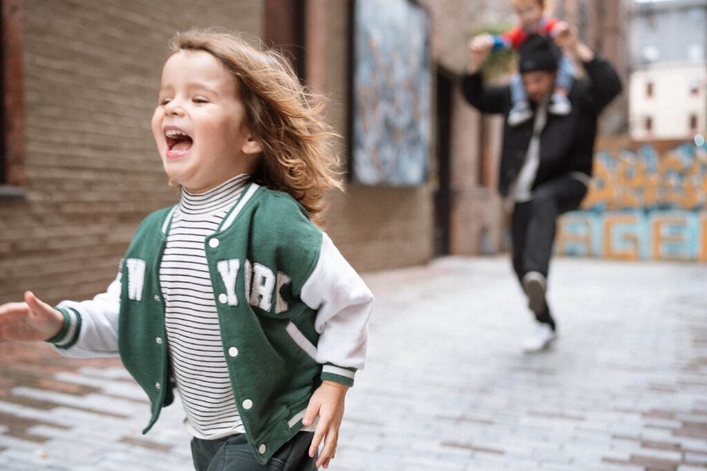 little boy running down alleyway in pioneer square