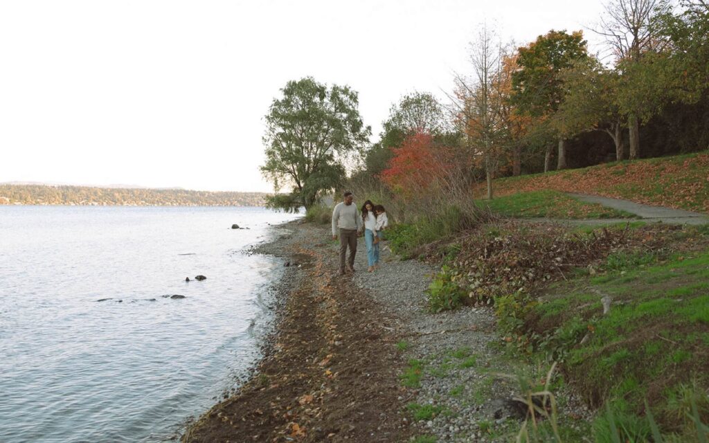 male and female walking along lake washington