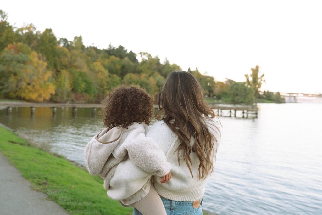 female walking with little girl on lake washington