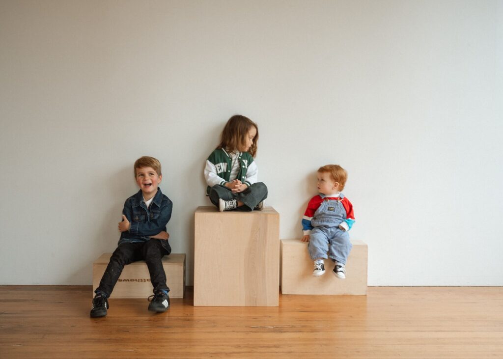 three little boys sitting on cubes in seattle studio