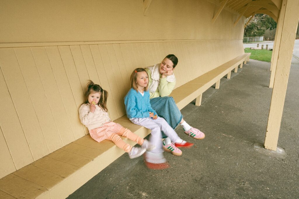 mother sitting with daughters at discovery park
