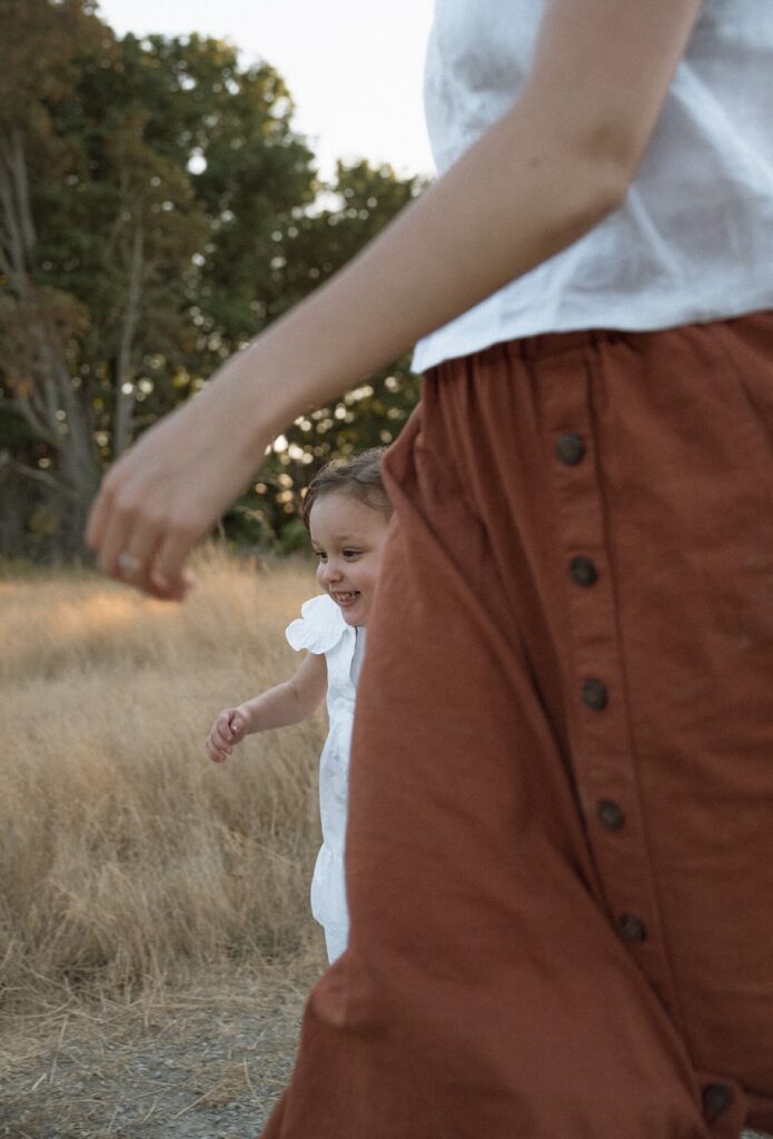 mother running with little girl at family photoshoot