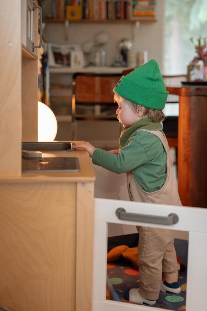 toddler playing with toy kitchen in seattle