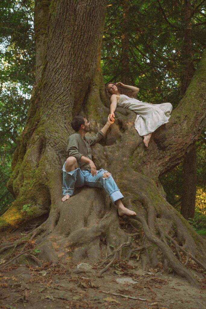 couple laying in tree at saint edward state park in kenmore