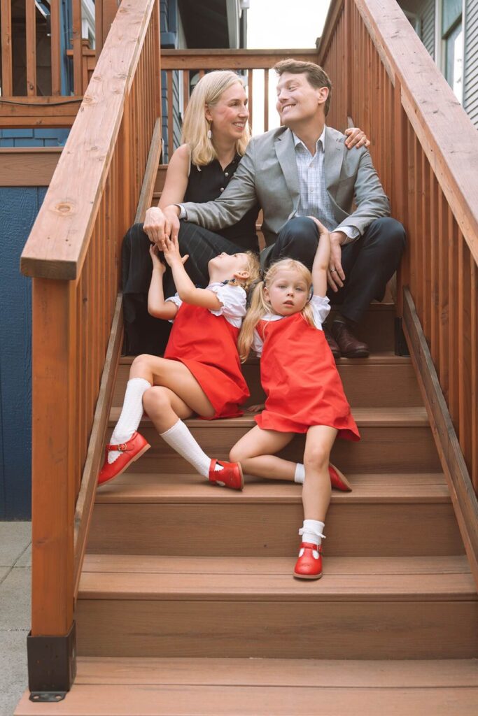 family of four sitting on stairs at home in seattle