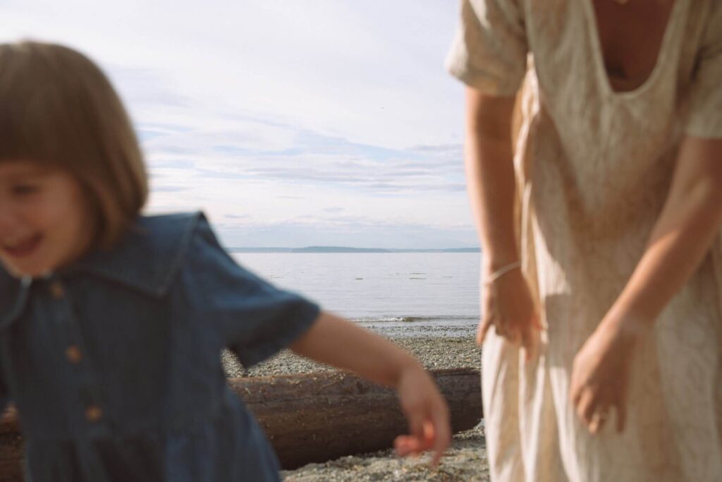 mother daughter play at beach