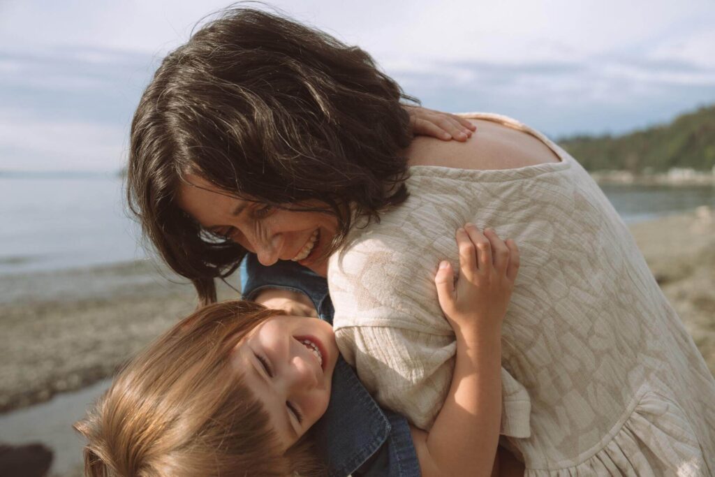 mother daughter play at beach