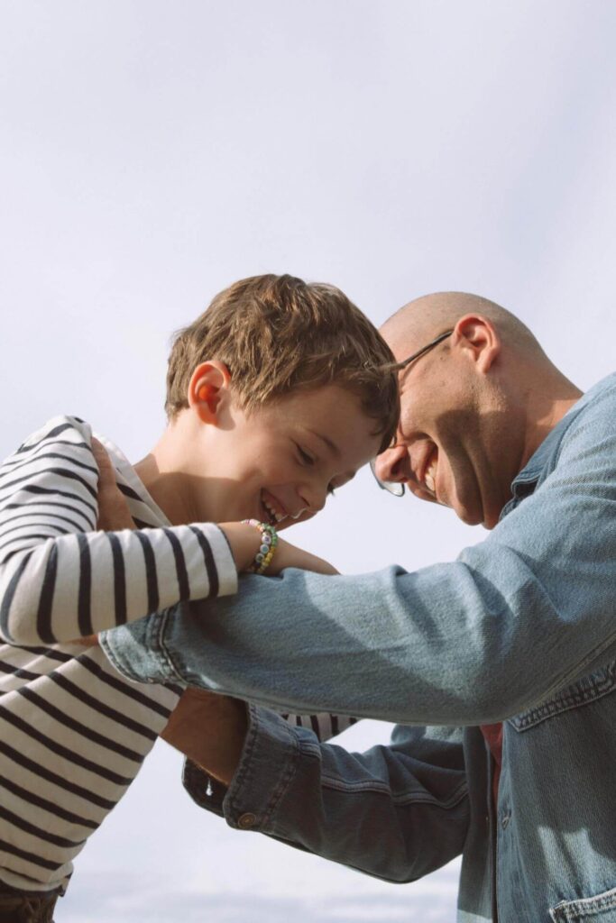 father son play at beach