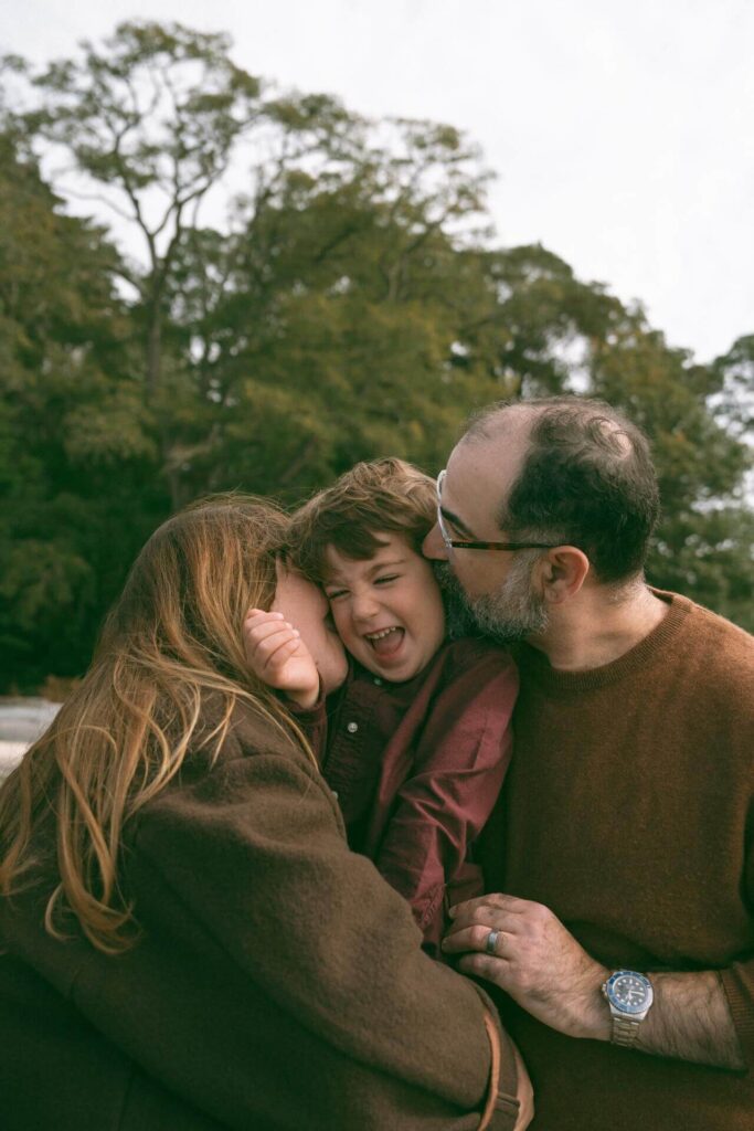 male and female hugging little boy