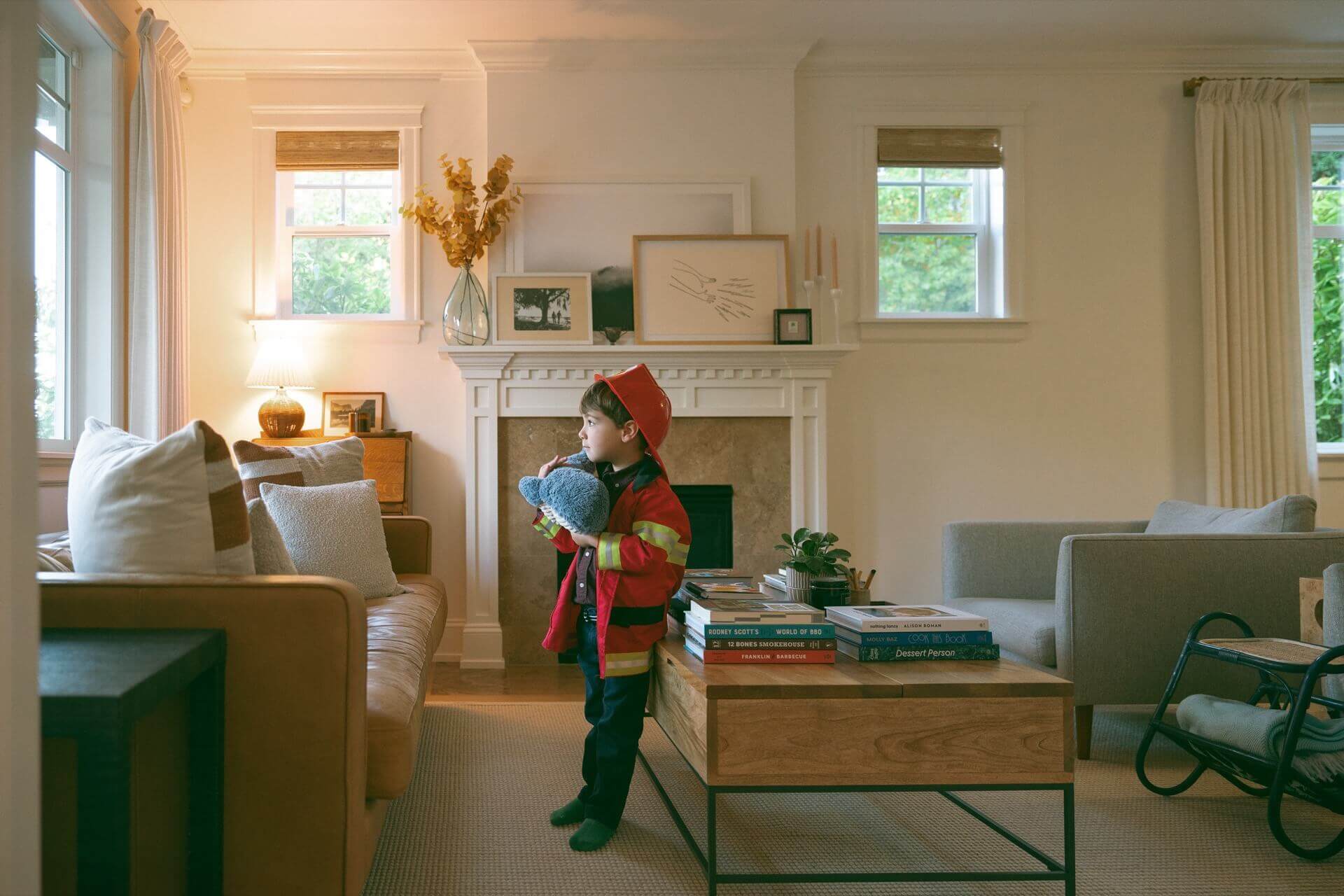 Child firefighter costume in a cozy living room