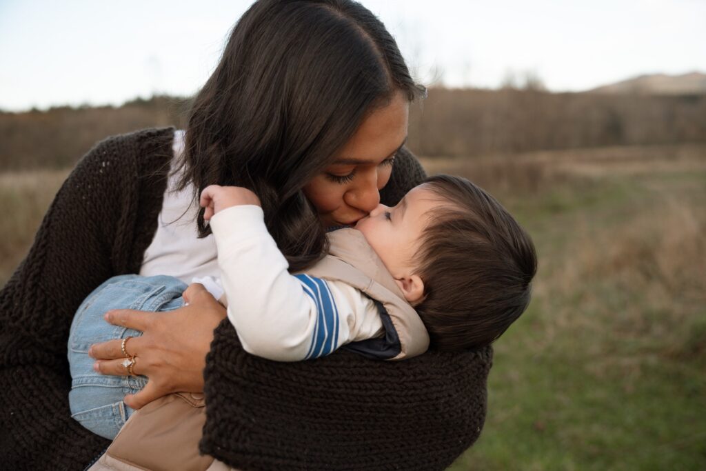 mother kissing baby boy