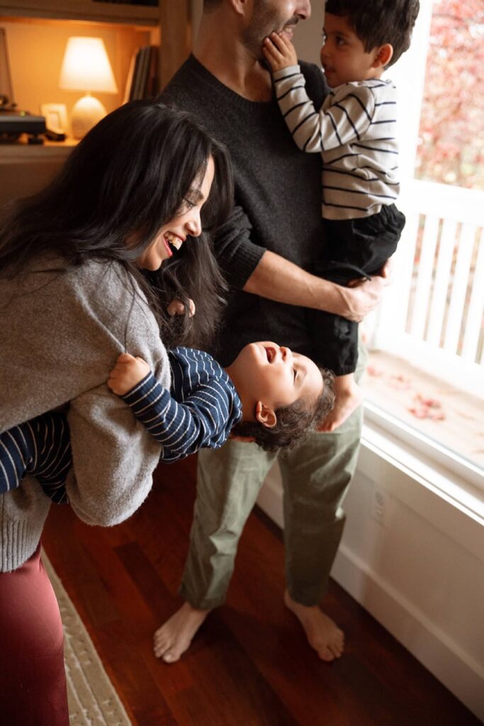 female playing with baby at home with family