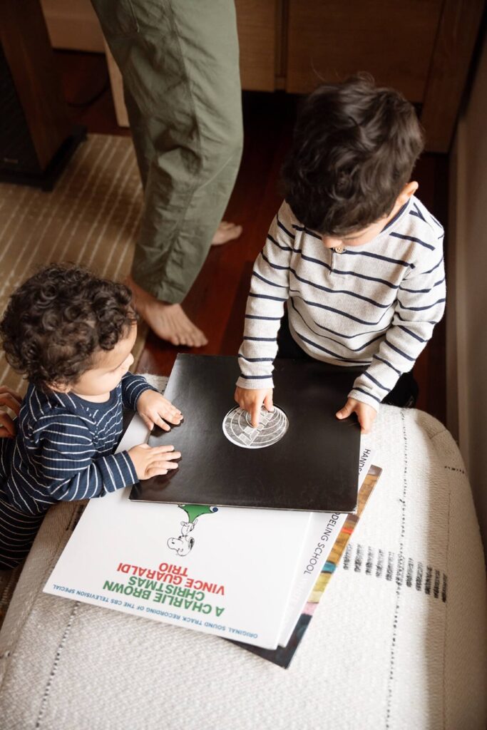 two kids pointing at record at home