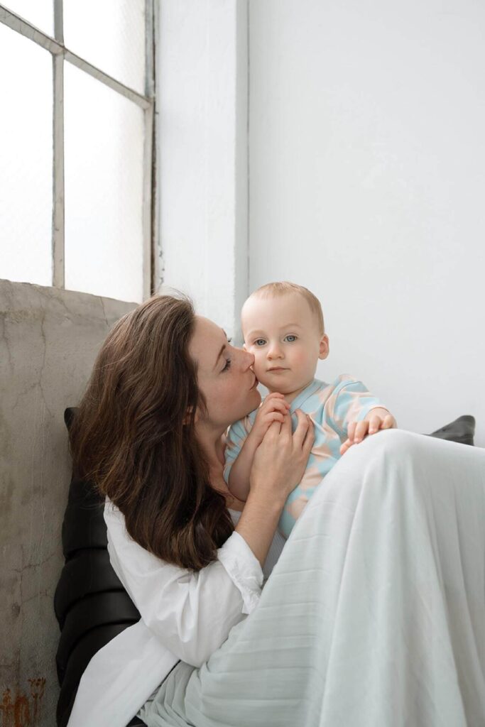 mother embracing baby boy in seattle studio