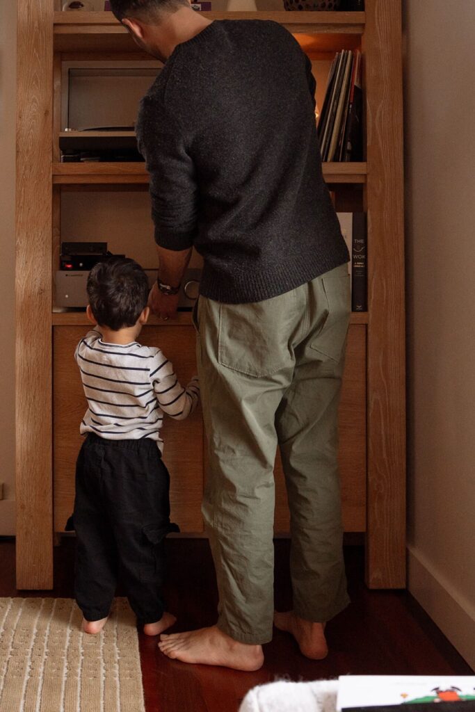 father and son arranging records in home