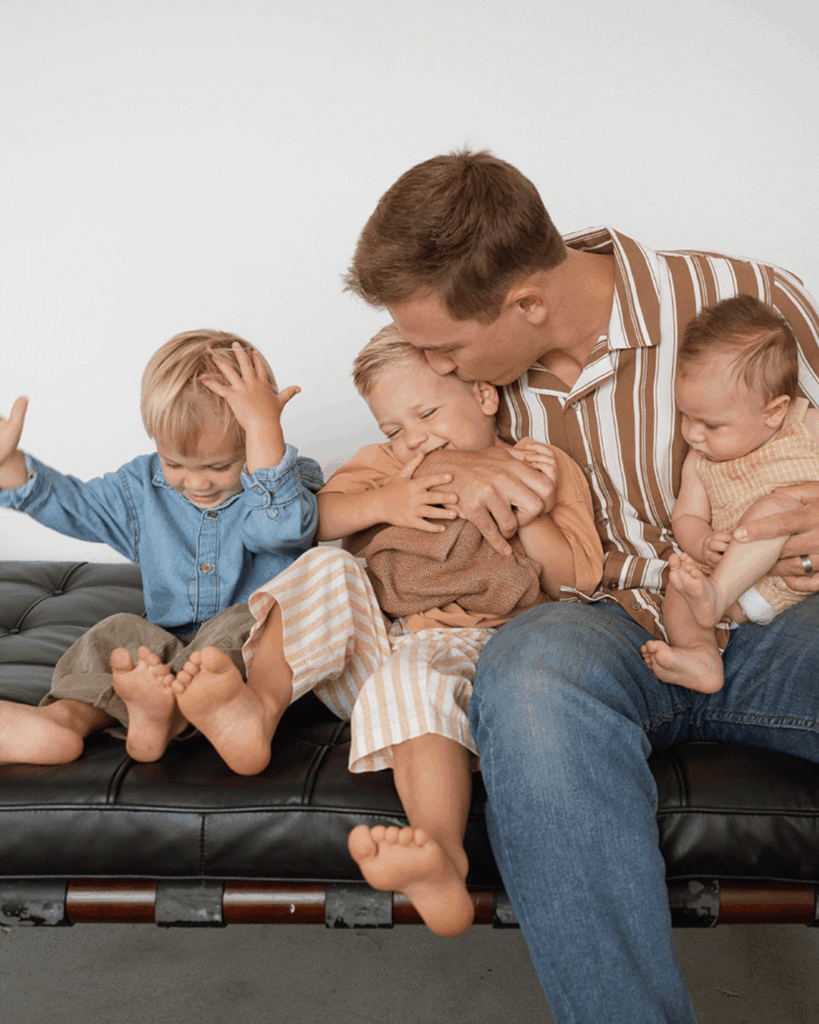 father with three kids in costa mesa photo studio