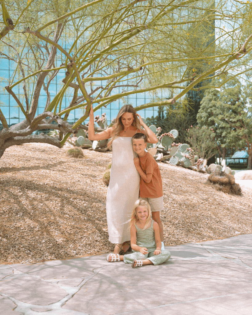 Mother with her two children posing together beneath a desert tree at Noguchi Garden in Costa Mesa.