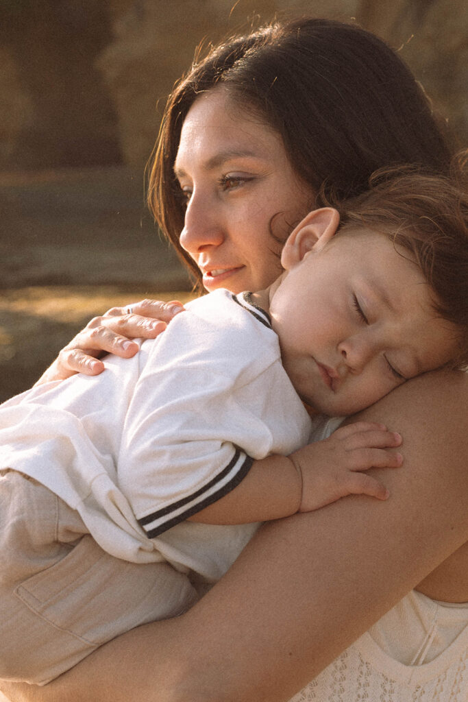 Mother holding her baby close during sunset at Shaw’s Cove.