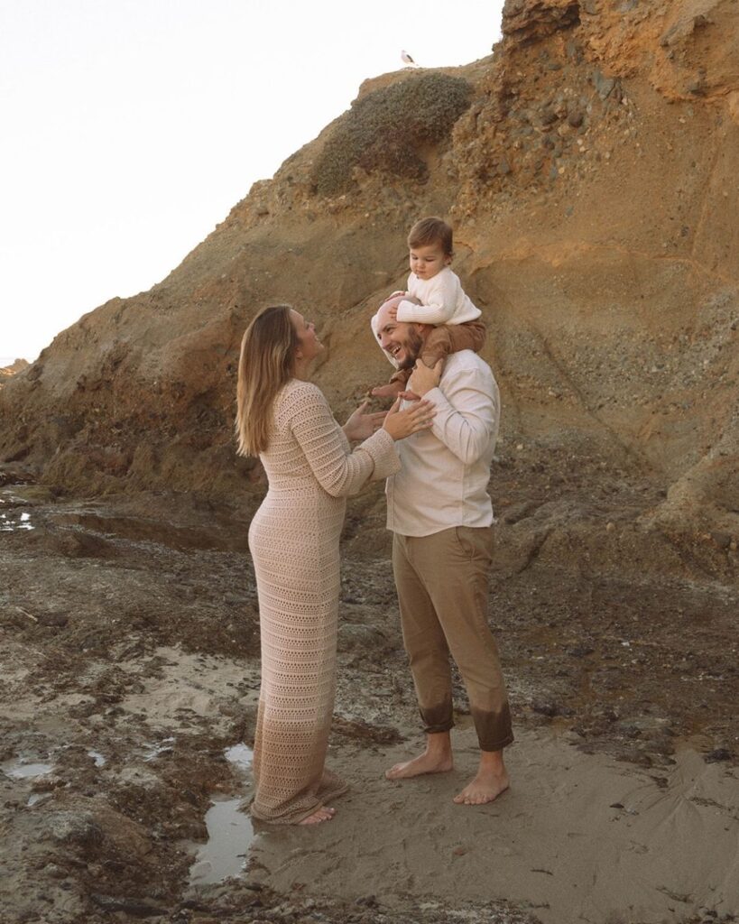 Parents laughing with their toddler during candid family photoshoot in Laguna Beach.