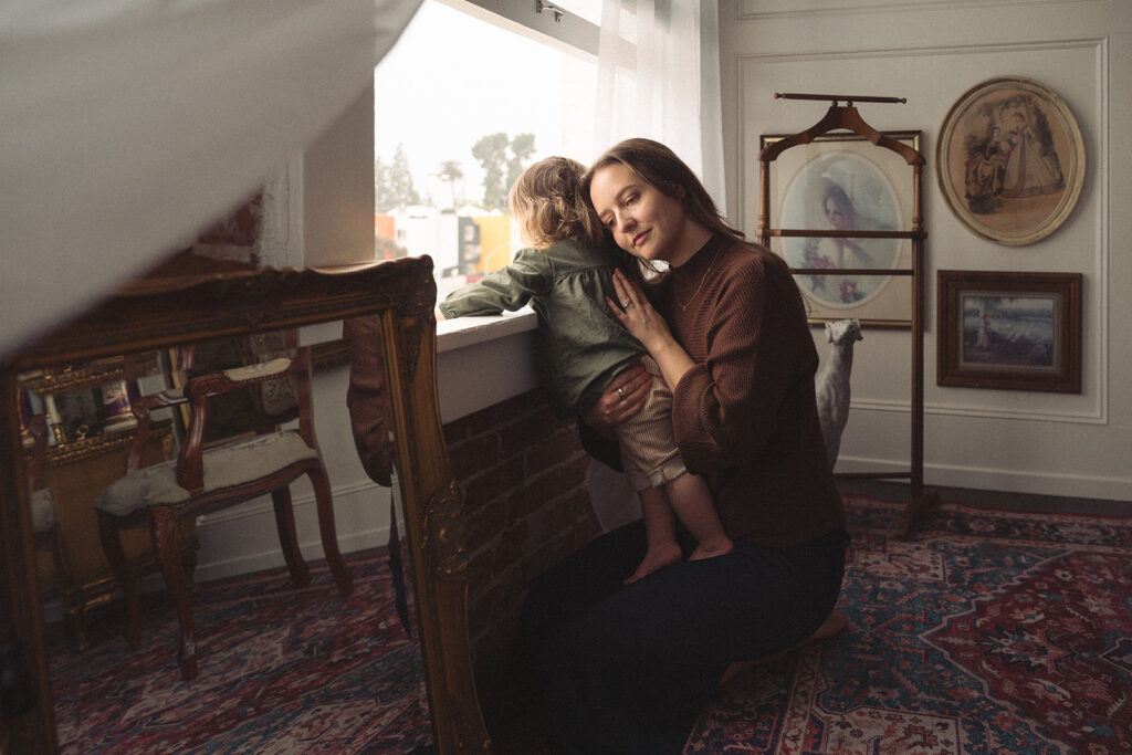Quiet morning moment between a mom and her baby in a studio designed to feel like home.