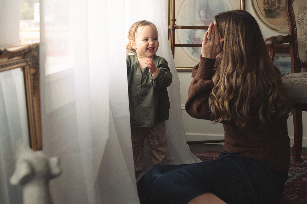 Unposed motherhood moment captured during family photos without posing, allowing kids to move freely and families to be themselves.