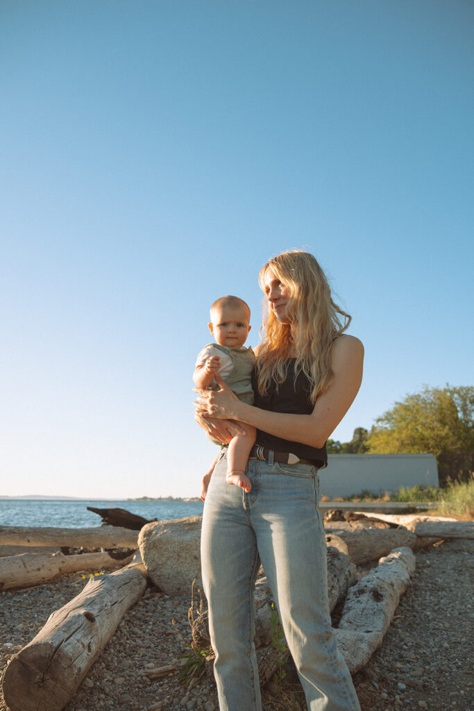 Golden hour portrait of dad holding baby against blue sky, Costa Mesa family photography