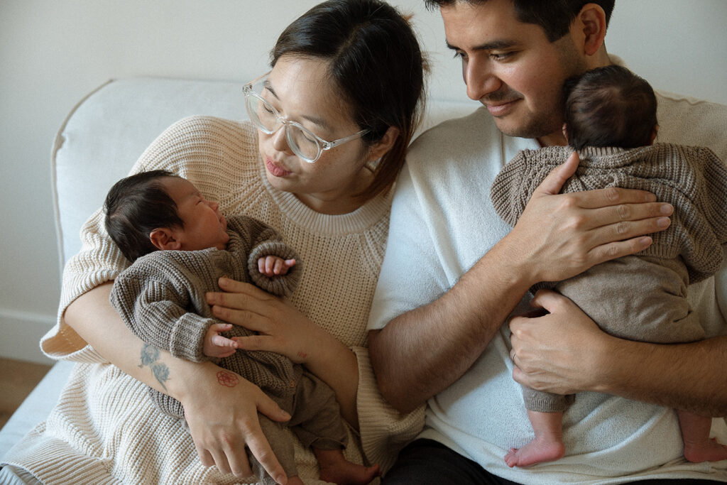 Close-up of Irvine parents holding newborn twins face-to-face — Orange County lifestyle newborn twin photography