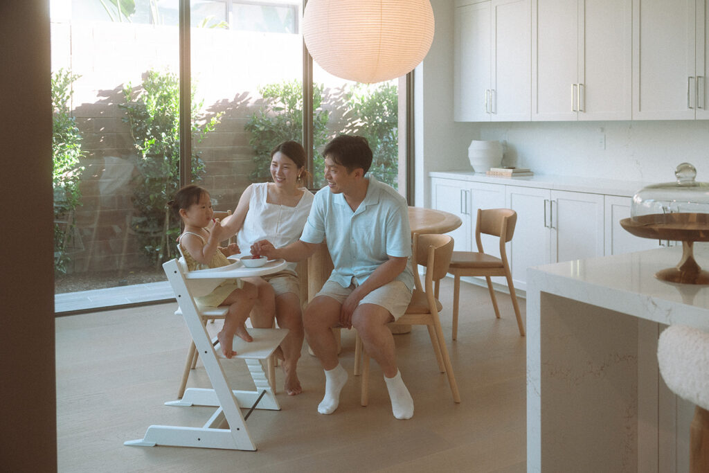 Irvine family photographer, candid afternoon moment with mom, dad, and daughter at home